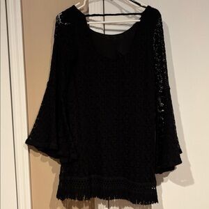 Beautiful black knitted dress with bell sleeves and trimmed hem with scoop back